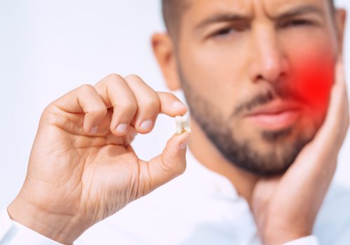 Man feeling pain after tooth extraction or tooth removal surgery. High quality photo